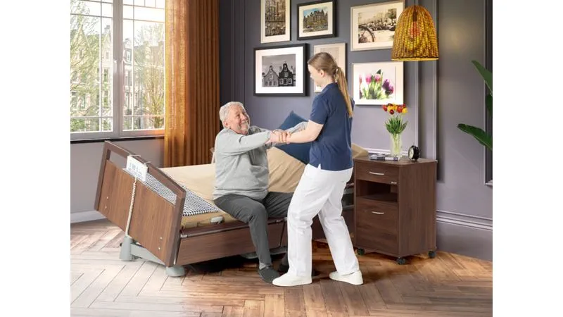 Carer using the Latera Neo lateral tilt to help a resident mobilise